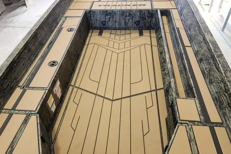 Slide: The Image of 2026 Tracker Grizzly 1756 T Marsh boat interior with camo design and tan flooring. - 4