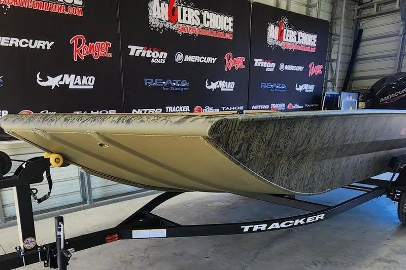 Slide: The Image of 2026 Tracker Grizzly 1756 T Marsh boat on trailer in showroom. - 6