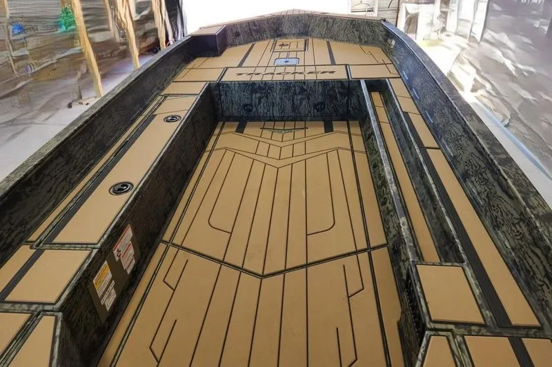 Slide: The Image of 2026 Tracker Grizzly 1756 T Marsh boat interior with custom flooring and storage compartments. - 7