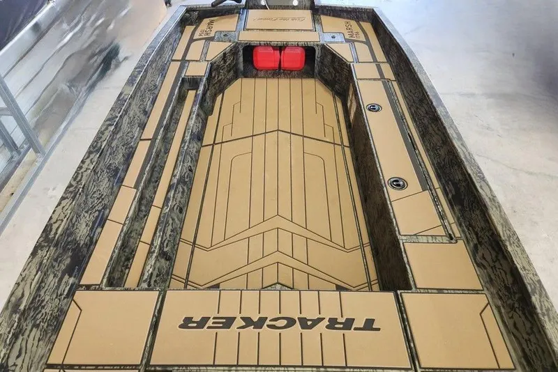 Slide: The Image of 2026 Tracker Grizzly 1756 T Marsh boat interior with custom flooring and storage compartments. - 8
