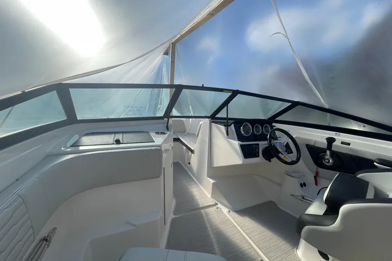 Slide: The Image of 2022 Sea Ray SPX 190 boat interior with steering wheel and dashboard. - 10