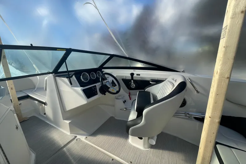 Slide: The Image of 2022 Sea Ray SPX 190 boat interior with steering wheel and seating. - 11