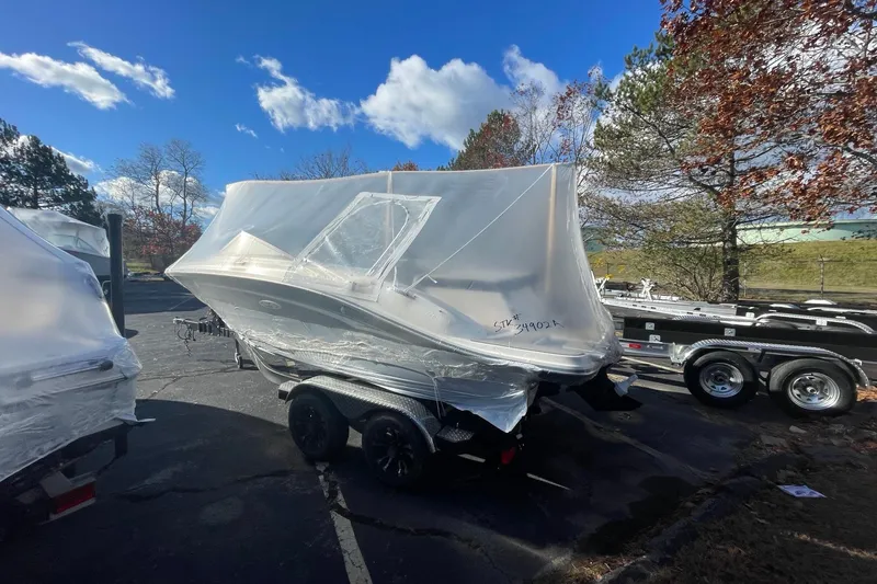 Slide: The Image of 2022 Sea Ray SPX 190 boat wrapped in protective cover on trailer. - 4