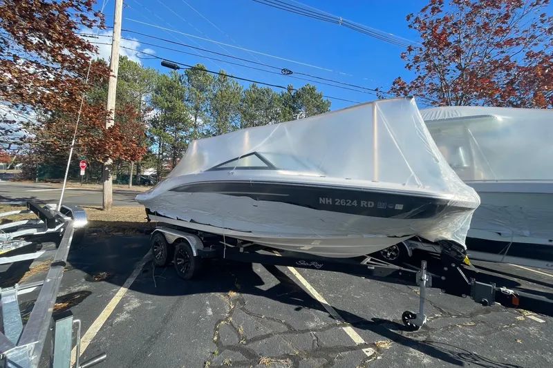 Slide: The Image of 2022 Sea Ray SPX 190 boat covered in protective wrap on a trailer. - 6