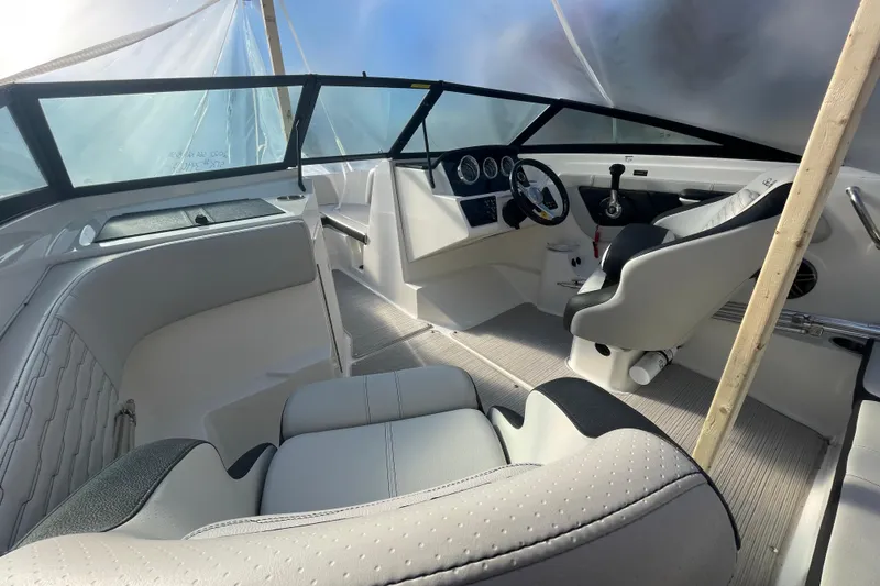 Slide: The Image of 2022 Sea Ray SPX 190 boat interior with modern dashboard and seating. - 9