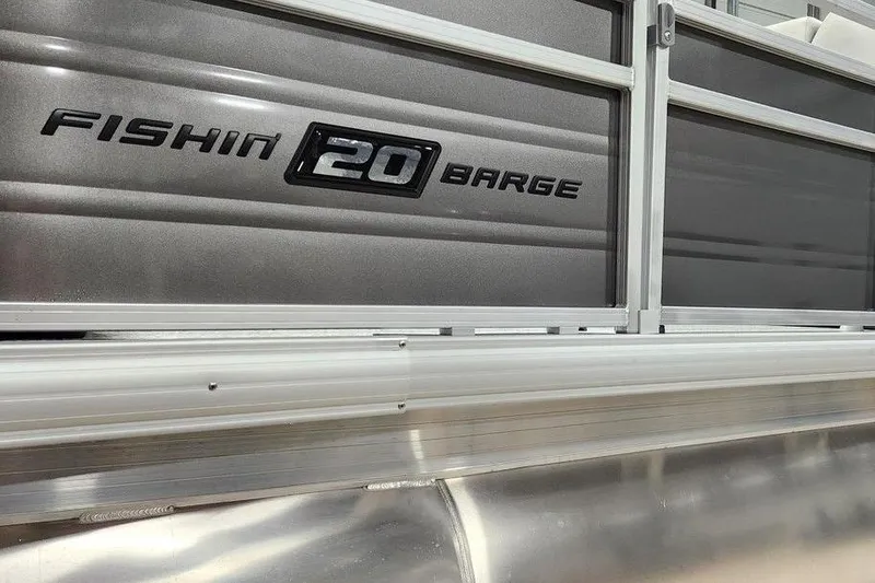 Slide: The Image of 2026 Sun Tracker Fishin' Barge 20 DLX interior with seating and storage features. - 12