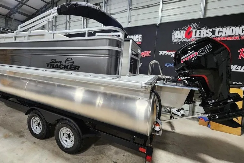 Slide: The Image of 2026 Sun Tracker Fishin' Barge 20 DLX pontoon boat with Mercury Pro XS engine in showroom. - 3