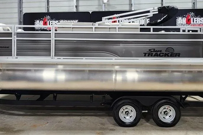 Slide: The Image of 2026 Sun Tracker Fishin' Barge 20 DLX pontoon boat in a showroom. - 4