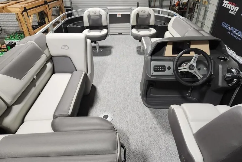 Slide: The Image of 2026 Sun Tracker Fishin' Barge 20 DLX interior with plush seating and modern design. - 7