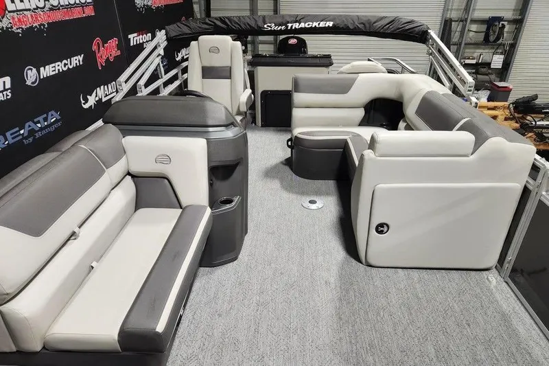 Slide: The Image of 2026 Sun Tracker Fishin' Barge 20 DLX interior with seating and storage. - 8