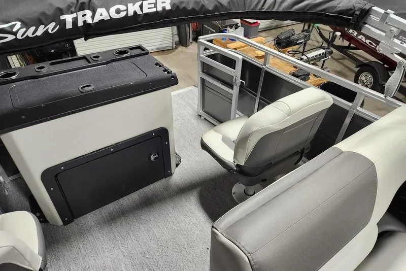 Slide: The Image of 2026 Sun Tracker Fishin' Barge 20 DLX interior with two swivel seats and carpeted floor. - 9