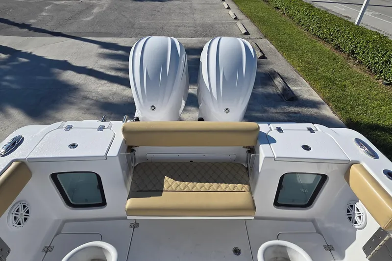 Slide: The Image of 2022 Sportsman Open 282TE Center Console boat with dual engines and cushioned seating. - 10