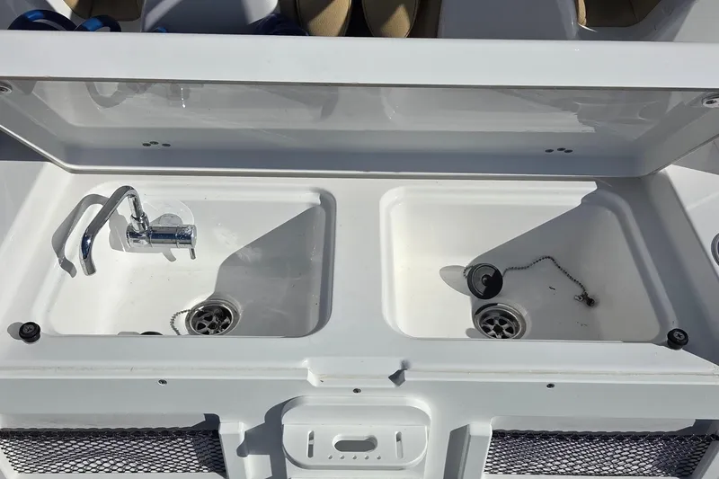 Slide: The Image of 2022 Sportsman Open 282TE Center Console dual sink with faucet and drain plugs. - 13