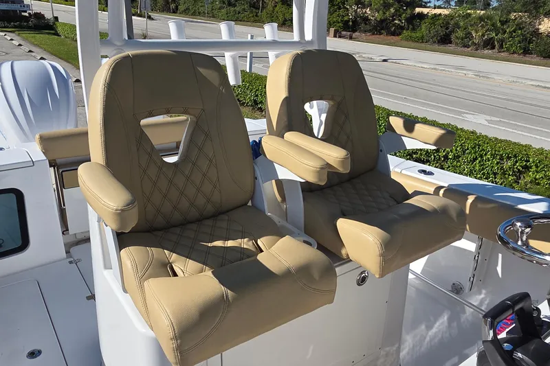 Slide: The Image of 2022 Sportsman Open 282TE Center Console with tan cushioned seats. - 15