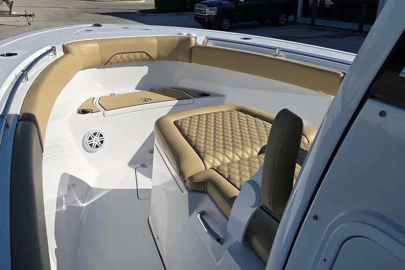 Slide: The Image of 2022 Sportsman Open 282TE Center Console boat interior with tan cushioned seating. - 16