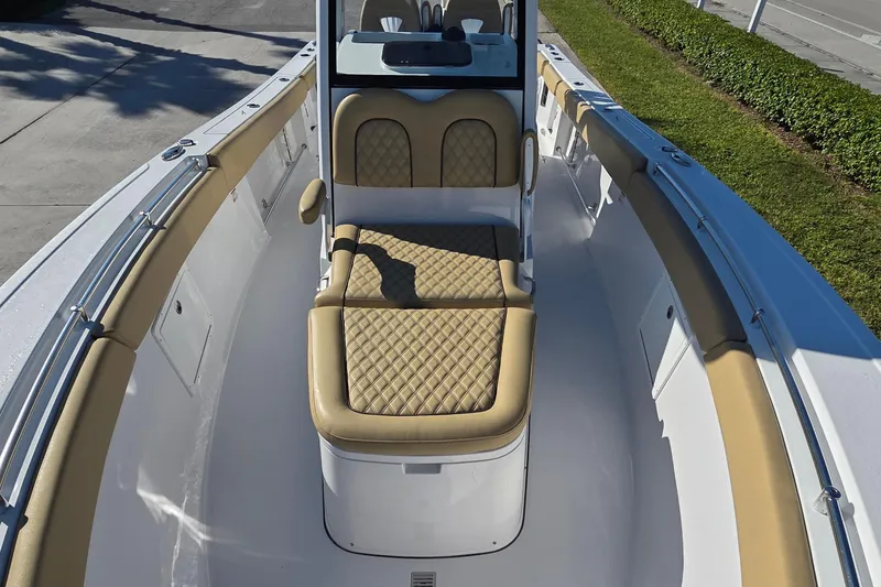 Slide: The Image of 2022 Sportsman Open 282TE Center Console boat with tan cushioned seating. - 17