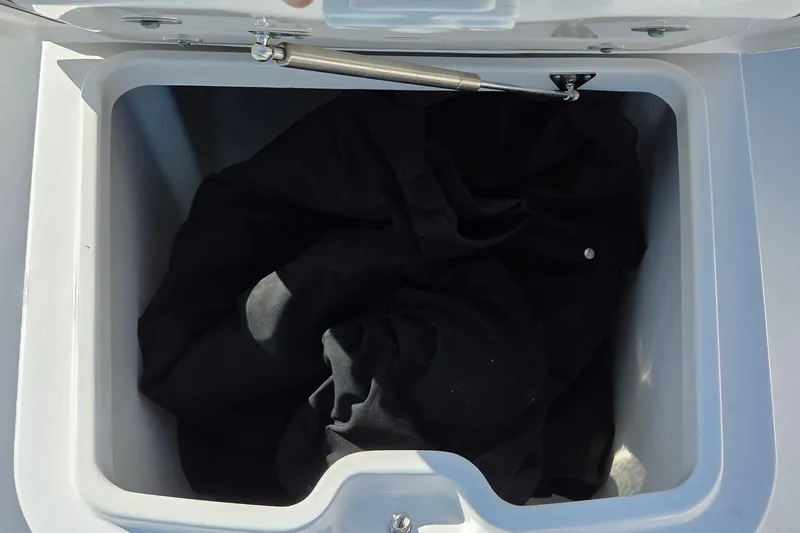 Slide: The Image of Open storage compartment on 2022 Sportsman Open 282TE Center Console boat. - 18