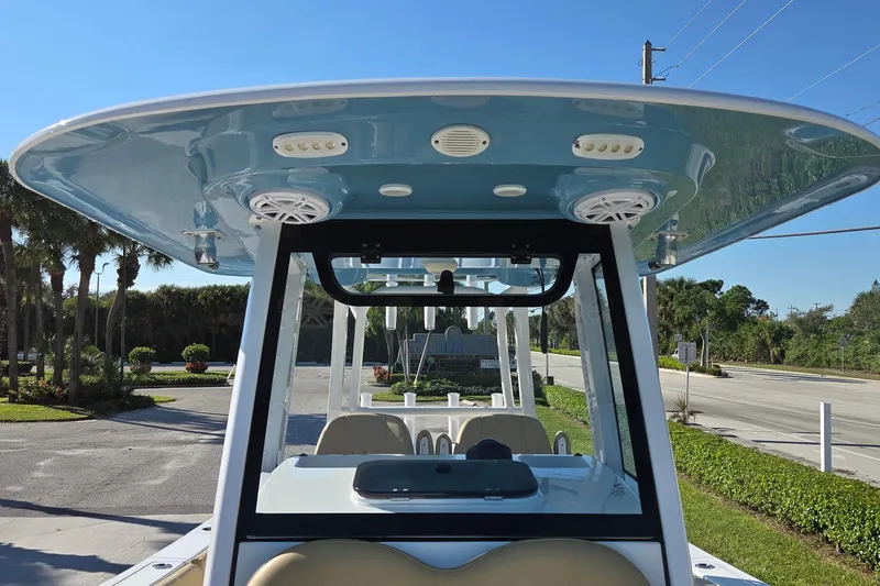 Slide: The Image of 2022 Sportsman Open 282TE Center Console boat with blue T-top and speakers. - 20