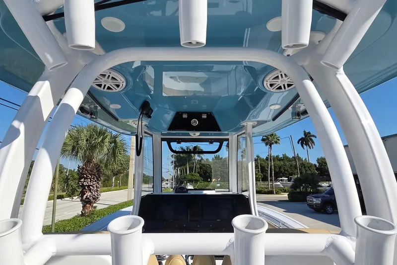 Slide: The Image of 2022 Sportsman Open 282TE Center Console boat with rod holders and blue T-top. - 21