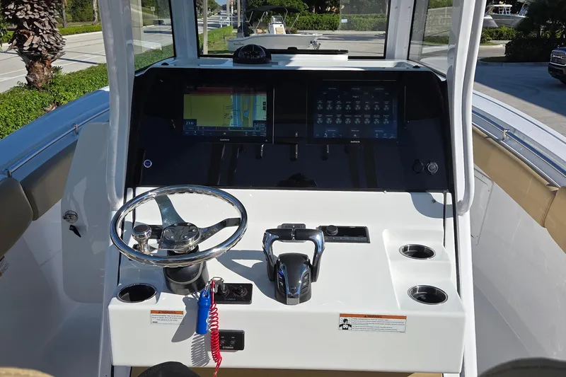 Slide: The Image of 2022 Sportsman Open 282TE Center Console dashboard with steering wheel and navigation display. - 4