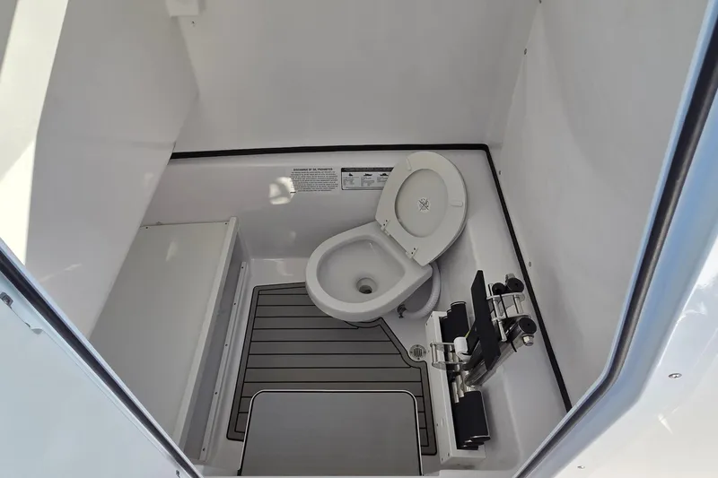 Slide: The Image of 2022 Sportsman Open 282TE Center Console boat interior with toilet. - 5