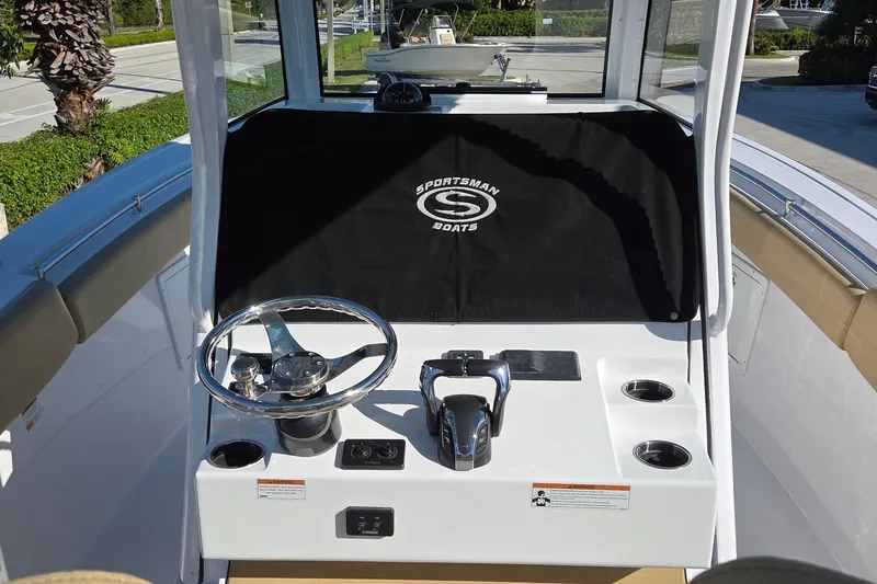 Slide: The Image of 2022 Sportsman Open 282TE Center Console boat helm with steering wheel and controls. - 6
