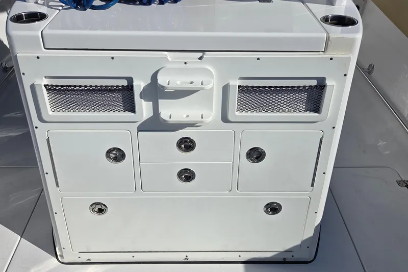 Slide: The Image of 2022 Sportsman Open 282TE Center Console storage unit with multiple compartments and cup holders. - 7