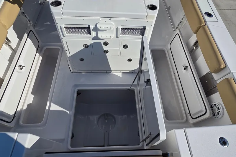 Slide: The Image of 2022 Sportsman Open 282TE Center Console boat interior with open storage compartments. - 8