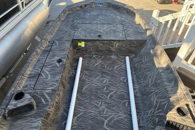 Slide: The Image of 2025 G3 1652 CC boat interior with camo pattern and storage compartments. - 9