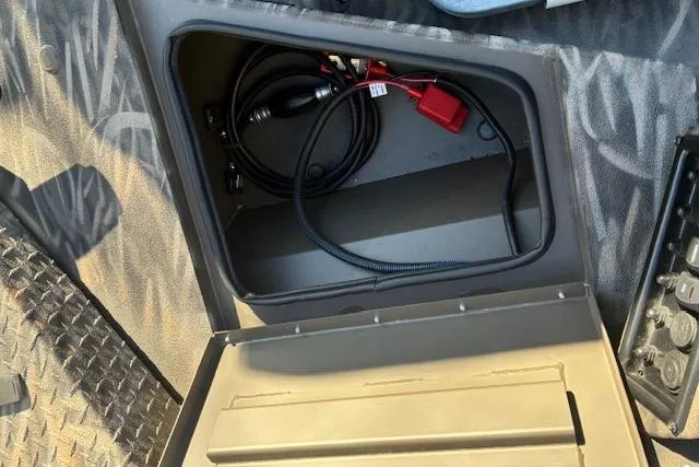 Slide: The Image of Open storage compartment in 2025 G3 1652 CC boat, showing cables and accessories. - 10