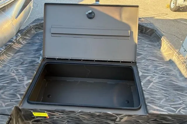 Slide: The Image of Open storage compartment on 2025 G3 1652 CC boat, featuring camo pattern. - 9