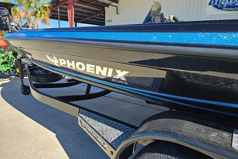Slide: The Image of 2026 Phoenix 920 Elite X boat with sleek black and blue design on trailer. - 11
