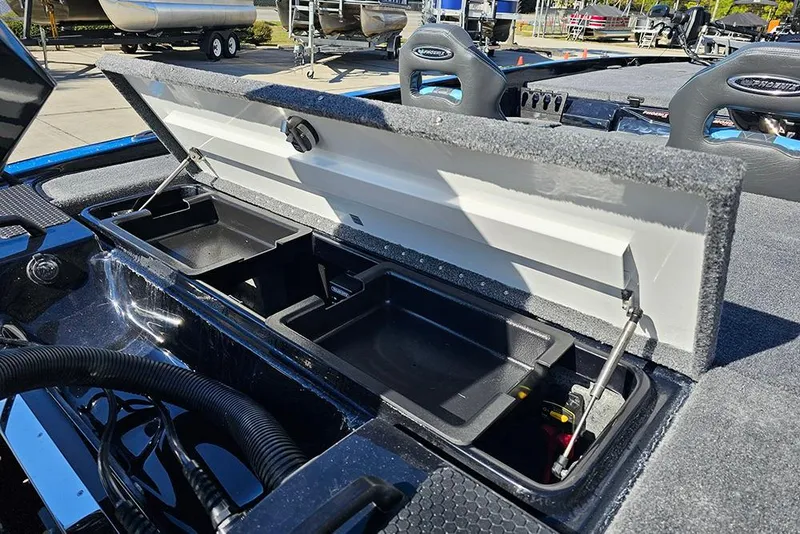 Slide: The Image of Open storage compartment in 2026 Phoenix 920 Elite X boat, showcasing interior features. - 13