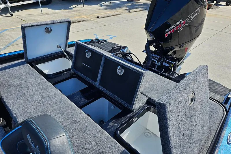 Slide: The Image of 2026 Phoenix 920 Elite X boat with open storage compartments and Mercury Pro XS engine. - 14