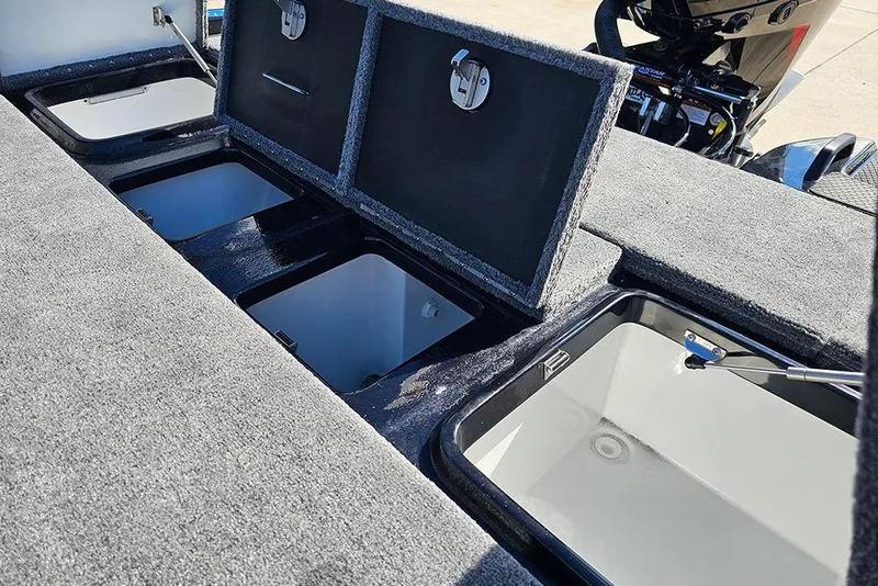 Slide: The Image of 2026 Phoenix 920 Elite X boat storage compartments with open lids, showcasing interior space. - 15