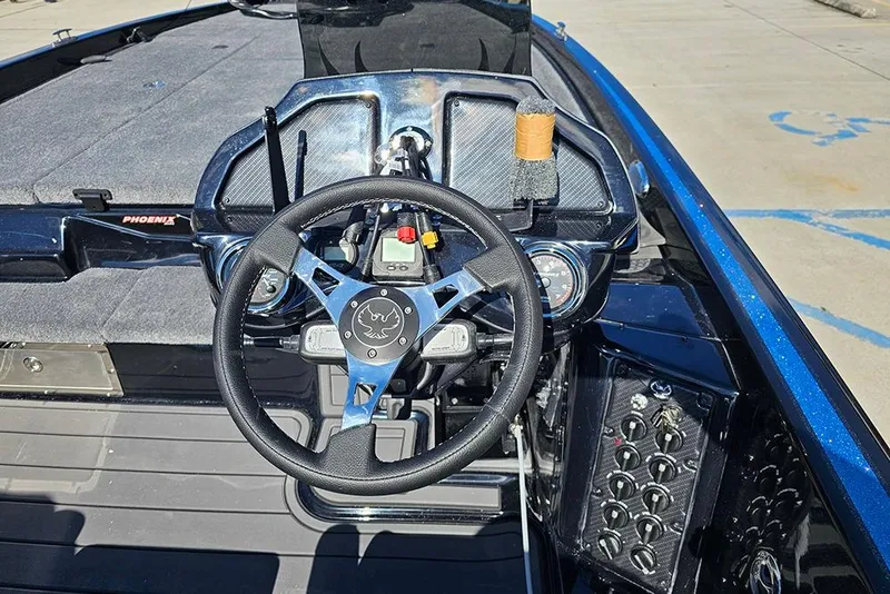 Slide: The Image of Steering console of 2026 Phoenix 920 Elite X boat with modern controls. - 16