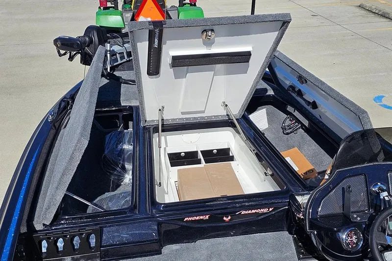 Slide: The Image of 2026 Phoenix 920 Elite X boat with open storage compartments and sleek design. - 25