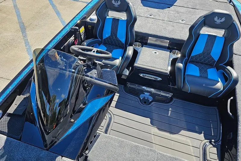Slide: The Image of 2026 Phoenix 920 Elite X boat interior with blue and black seats, steering console. - 29
