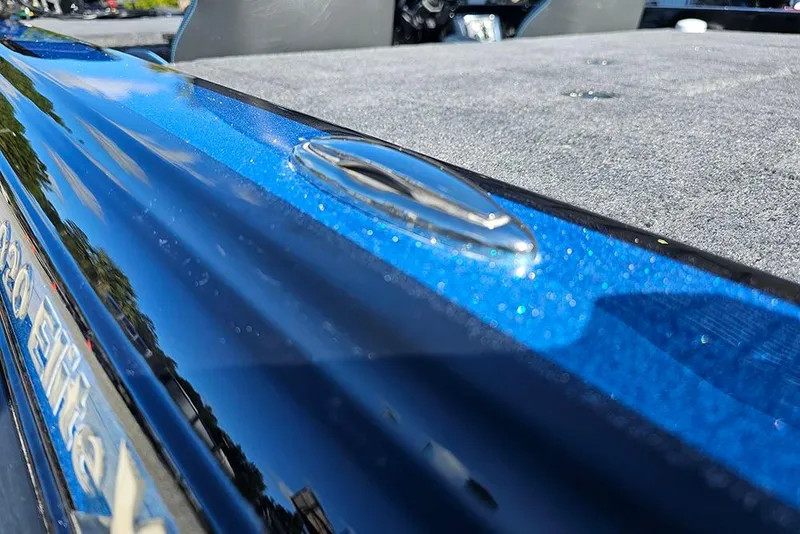 Slide: The Image of Close-up of a 2026 Phoenix 920 Elite X boat, showcasing sleek blue finish and deck details. - 30