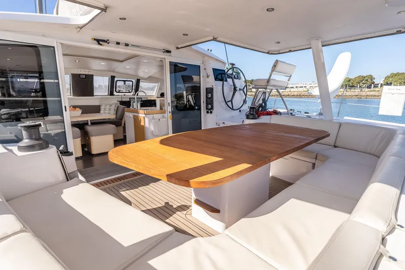 Slide: The Image of Luxurious 2014 Outremer 51 catamaran interior with spacious seating and wooden table. - 13