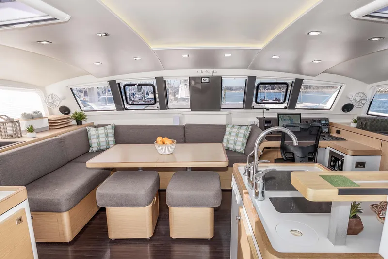 Slide: The Image of Luxurious interior of 2014 Outremer 51 catamaran with modern kitchen and seating area. - 16