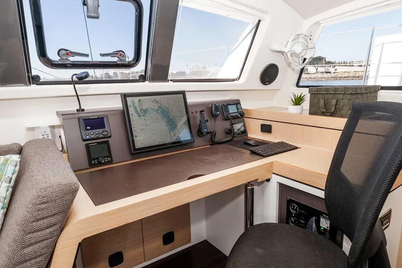 Slide: The Image of Navigation station of 2014 Outremer 51 catamaran with modern equipment and comfortable seating. - 22