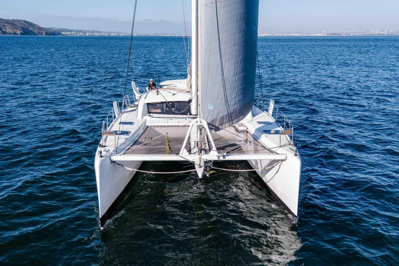 Slide: The Image of 2014 Outremer 51 catamaran sailing on open sea, front view. - 3