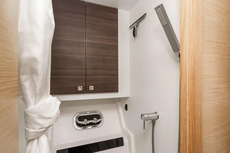 Slide: The Image of Bathroom interior of 2014 Outremer 51 yacht with modern shower and wooden cabinets. - 31