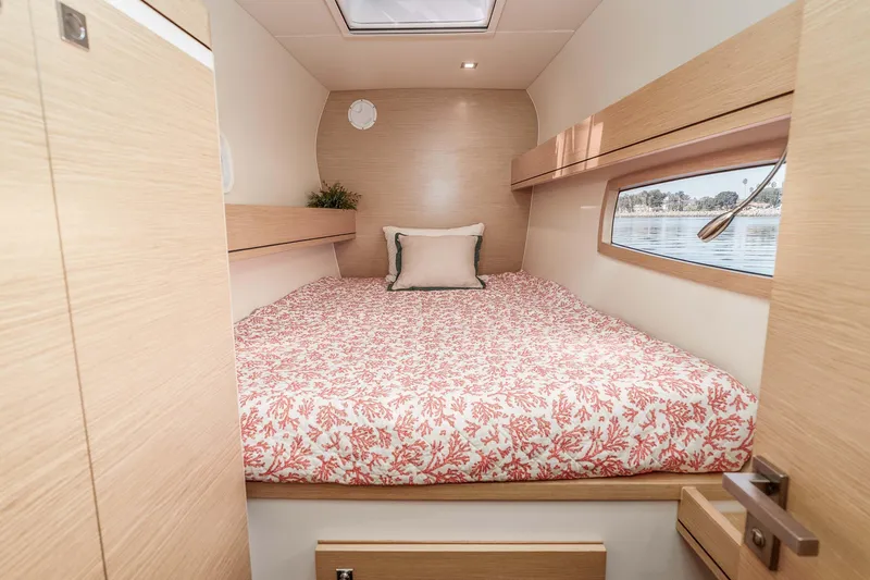 Slide: The Image of Cozy cabin interior of 2014 Outremer 51 yacht with floral bedding and window view. - 32