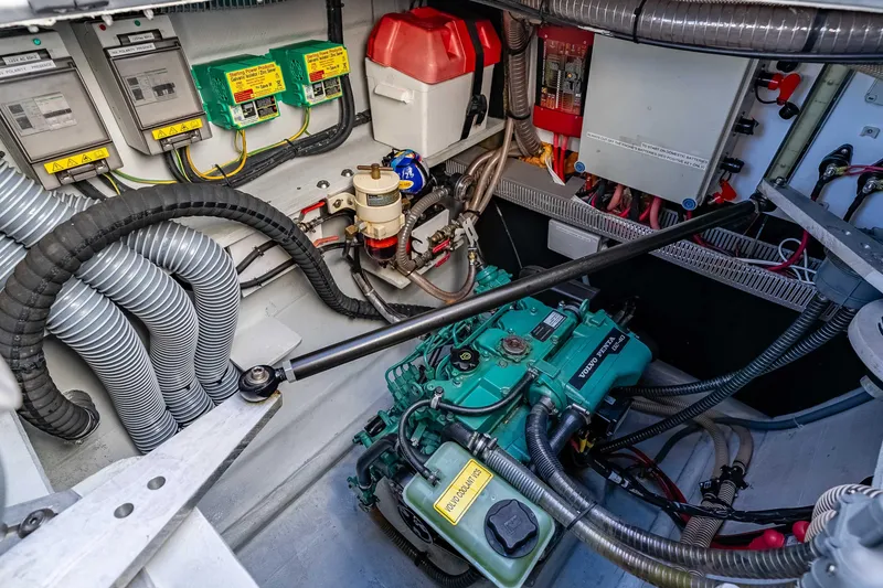 Slide: The Image of Engine room of a 2014 Outremer 51 catamaran, featuring Volvo Penta components and electrical systems. - 34