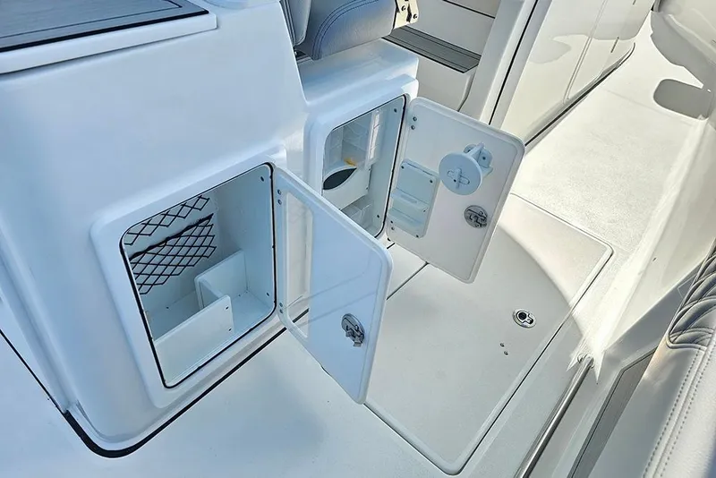 Slide: The Image of 2026 Sea Pro 322 Offshore boat storage compartments with open doors, showcasing interior features. - 22