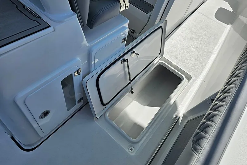 Slide: The Image of 2026 Sea Pro 322 Offshore boat storage compartment with open hatch and seating detail. - 24