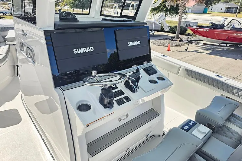 Slide: The Image of 2026 Sea Pro 322 Offshore boat cockpit with dual Simrad displays and modern controls. - 28