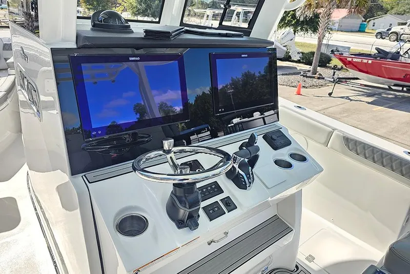 Slide: The Image of 2026 Sea Pro 322 Offshore boat dashboard with dual Simrad displays and steering wheel. - 29